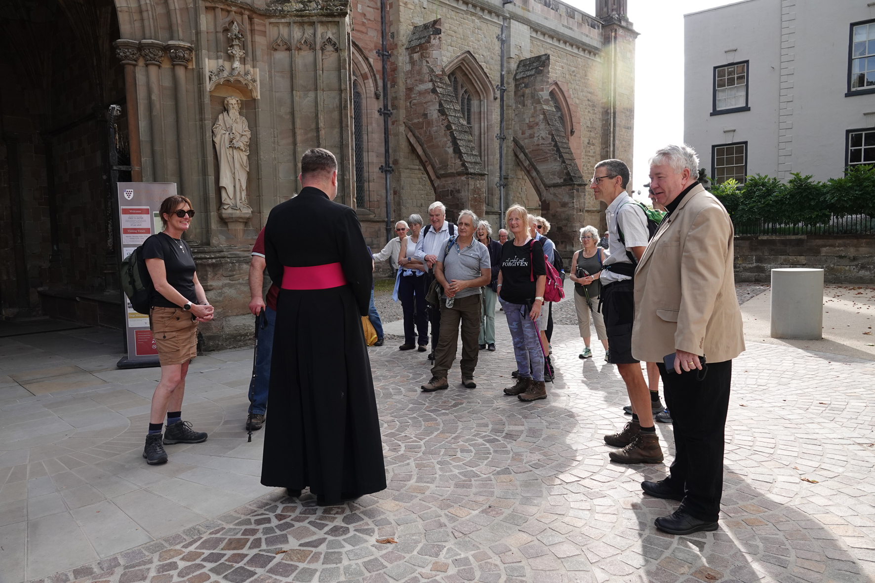 The dean meets pilgrims outside the North Porch of the Cathedral