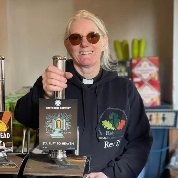 The Revd Sarah Jayne Hewitt pulling a pint of 'stairway to heaven' beer