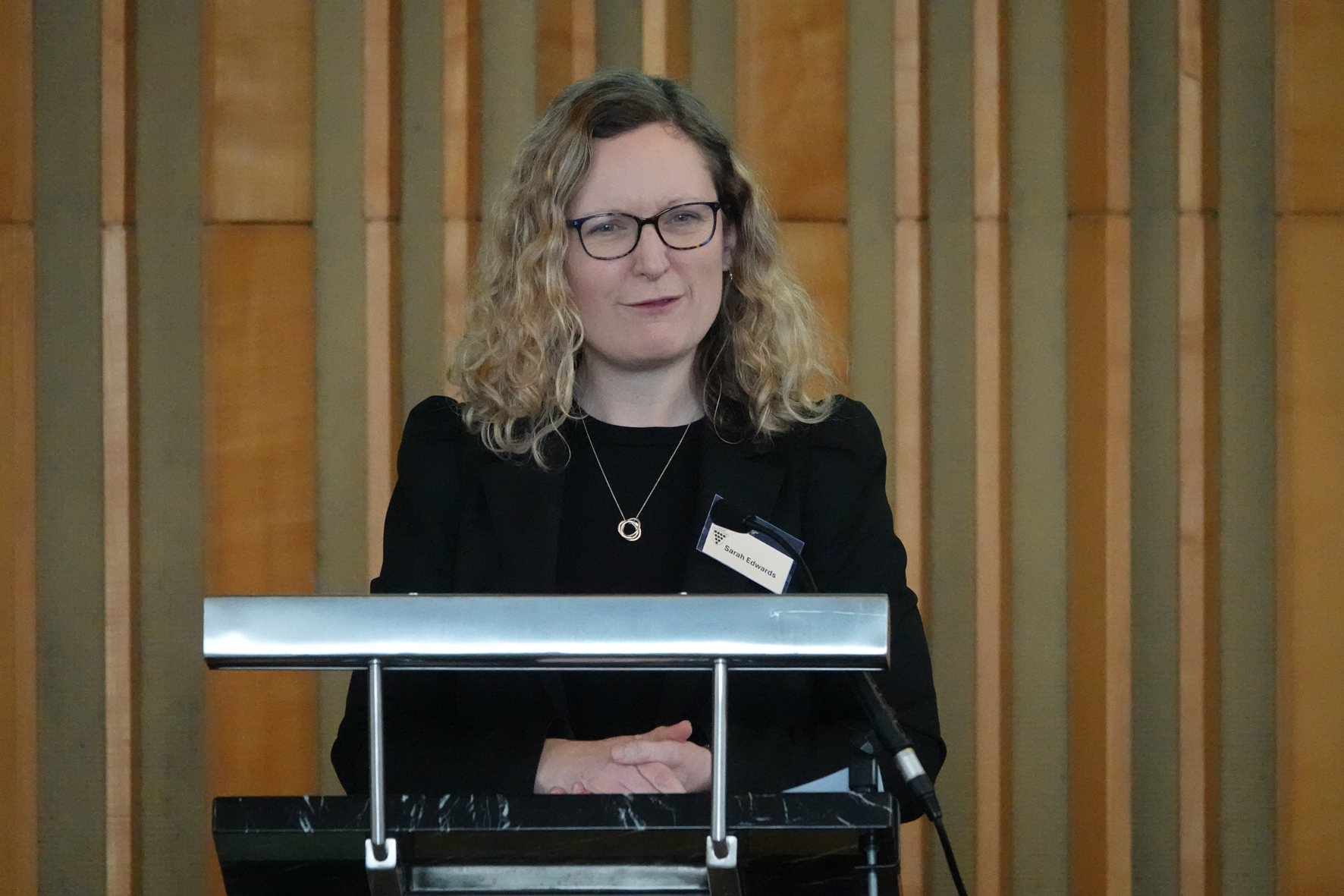 Sarah Edwards from Just Money standing at a podium