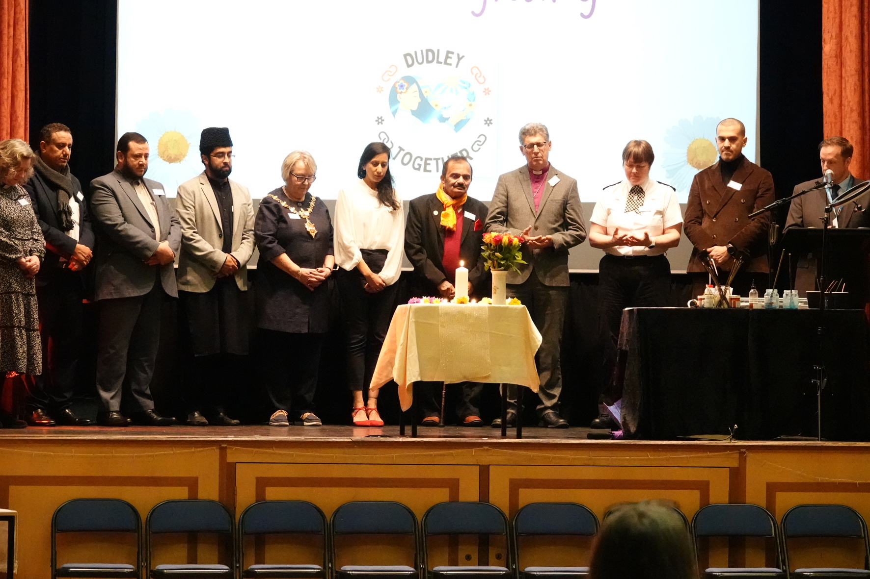 Community representatives on stage after the candle lighting ceremony