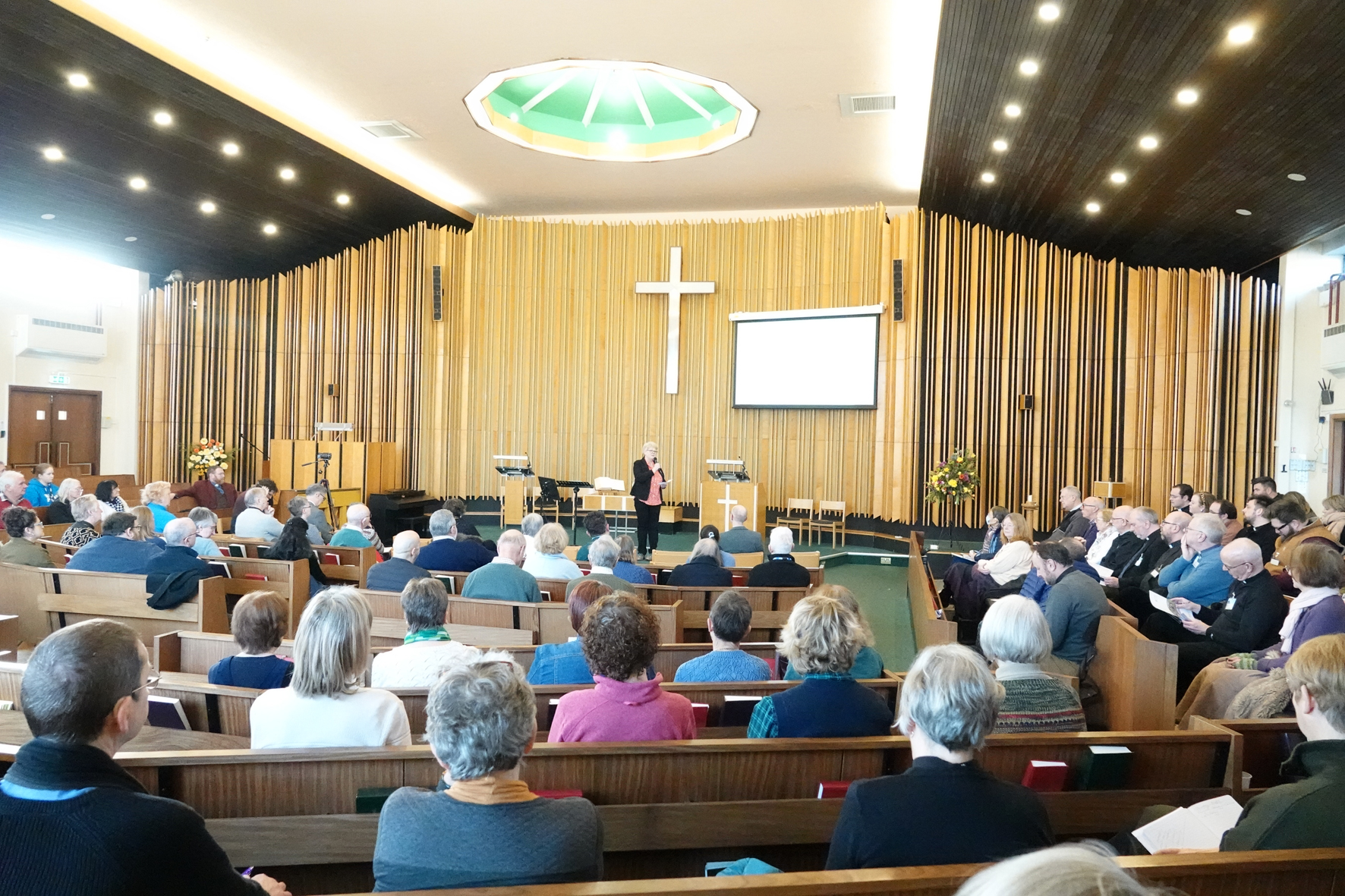 People gathered in a church to listen to Mark Earey