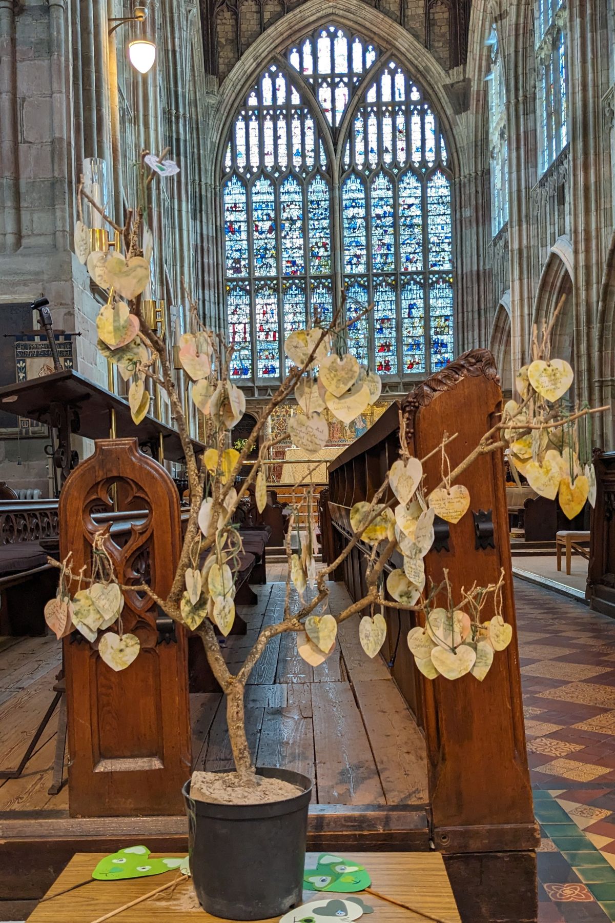 Tree with green eco leaf 'pledges' at Malvern Priory