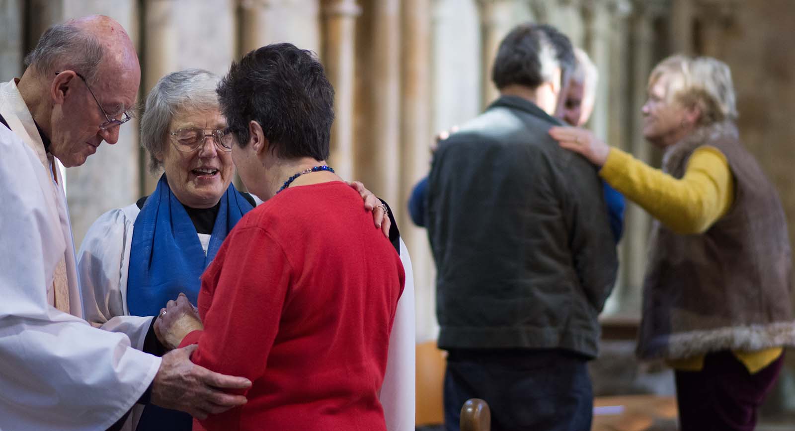 People praying with individuals