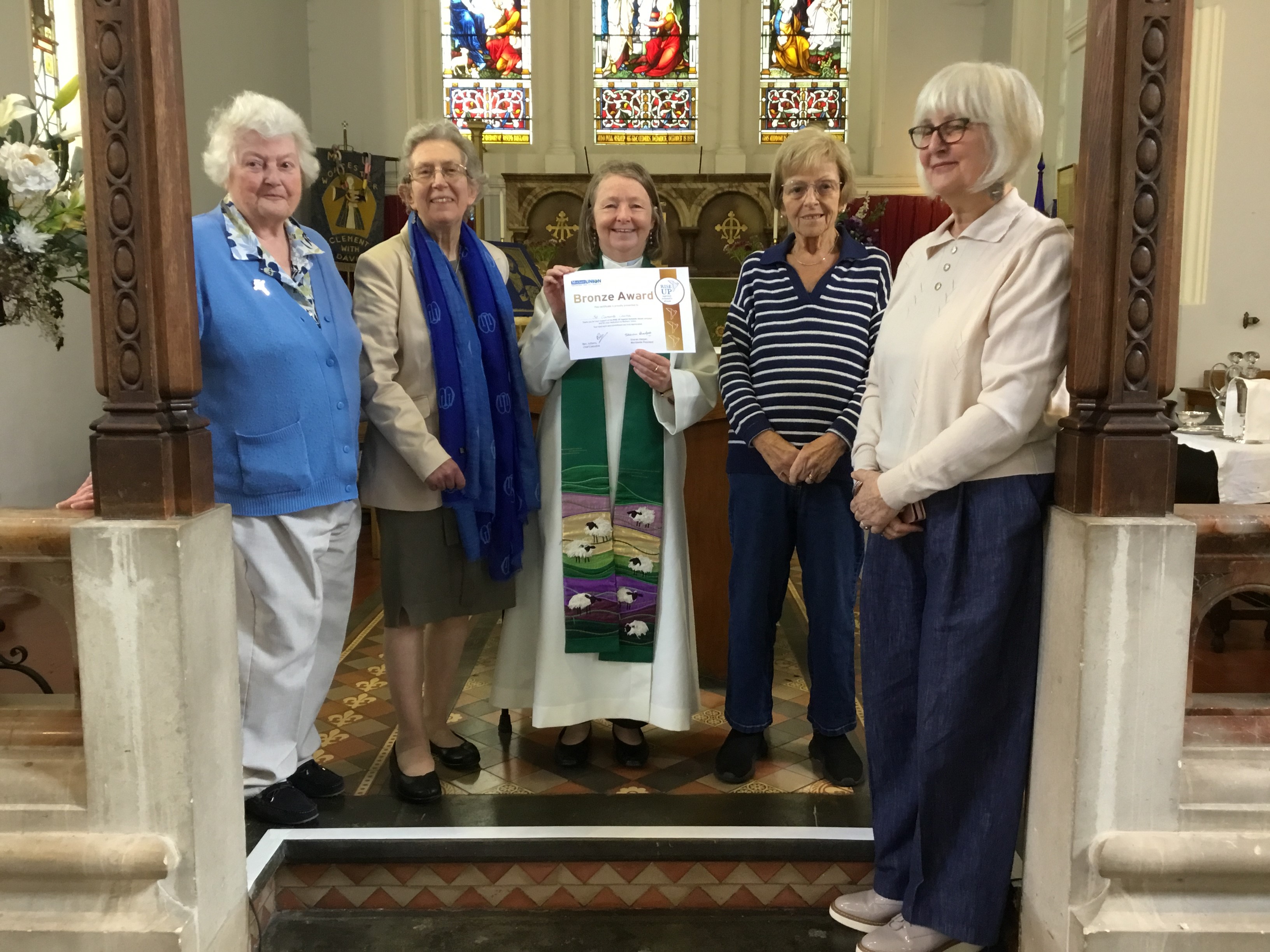Vicar Sarah Cotrill receives the Rise up award from the MU