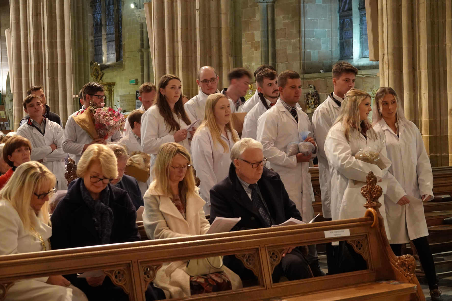 Young farmers bringing up gifts at the front of the cathedral