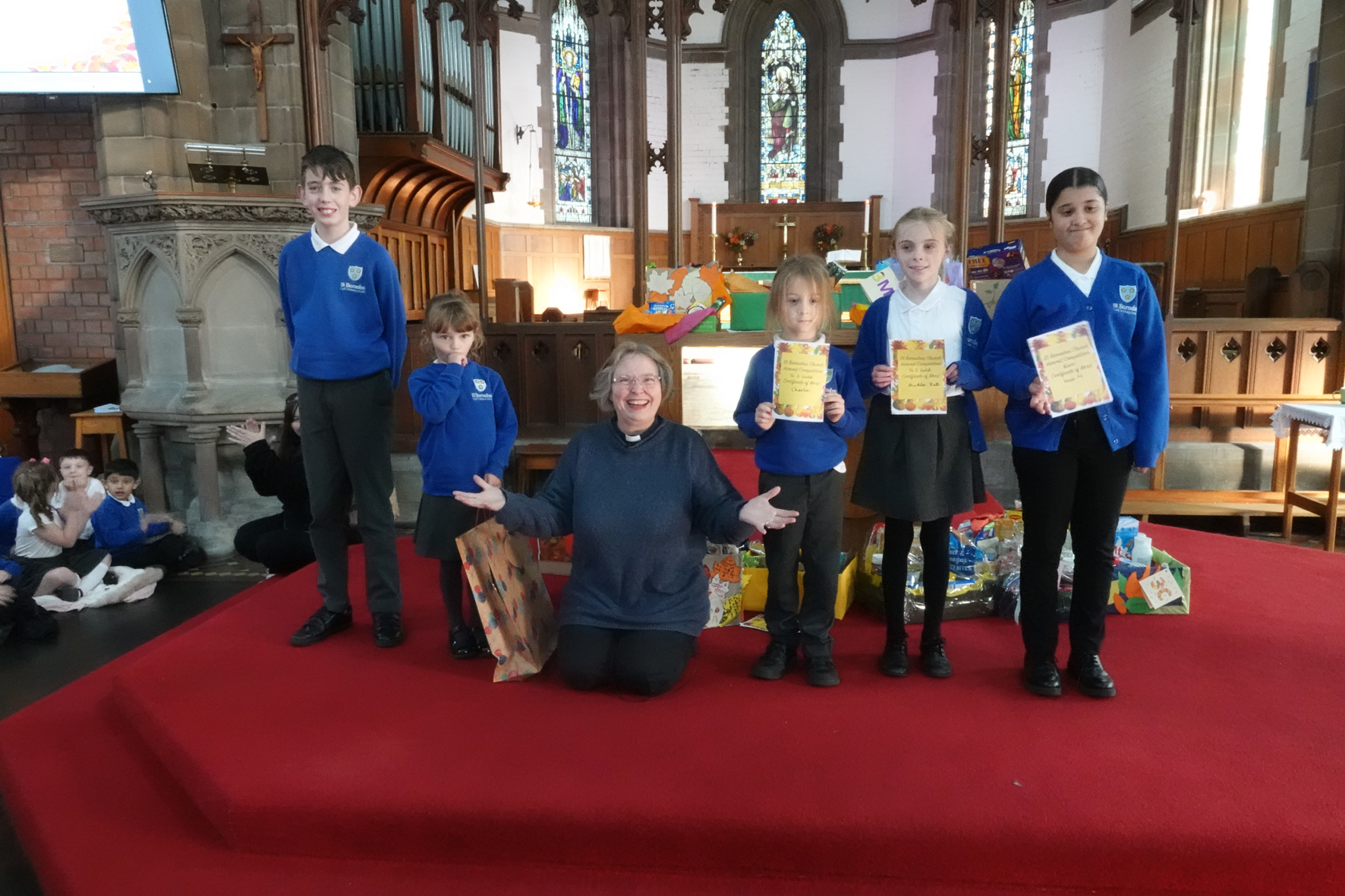 The Revd Sarah Northall with competition winners from St Barnabas school