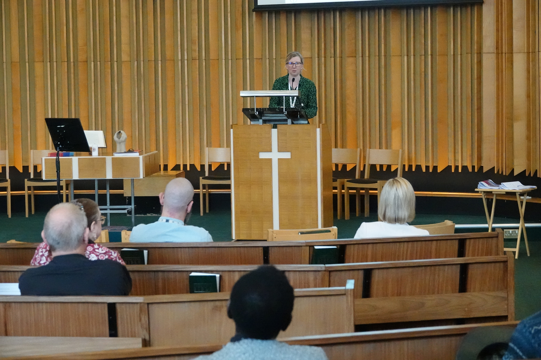 Nadia at the podium of Worcester Methodist Church talking to clergy at a study morning