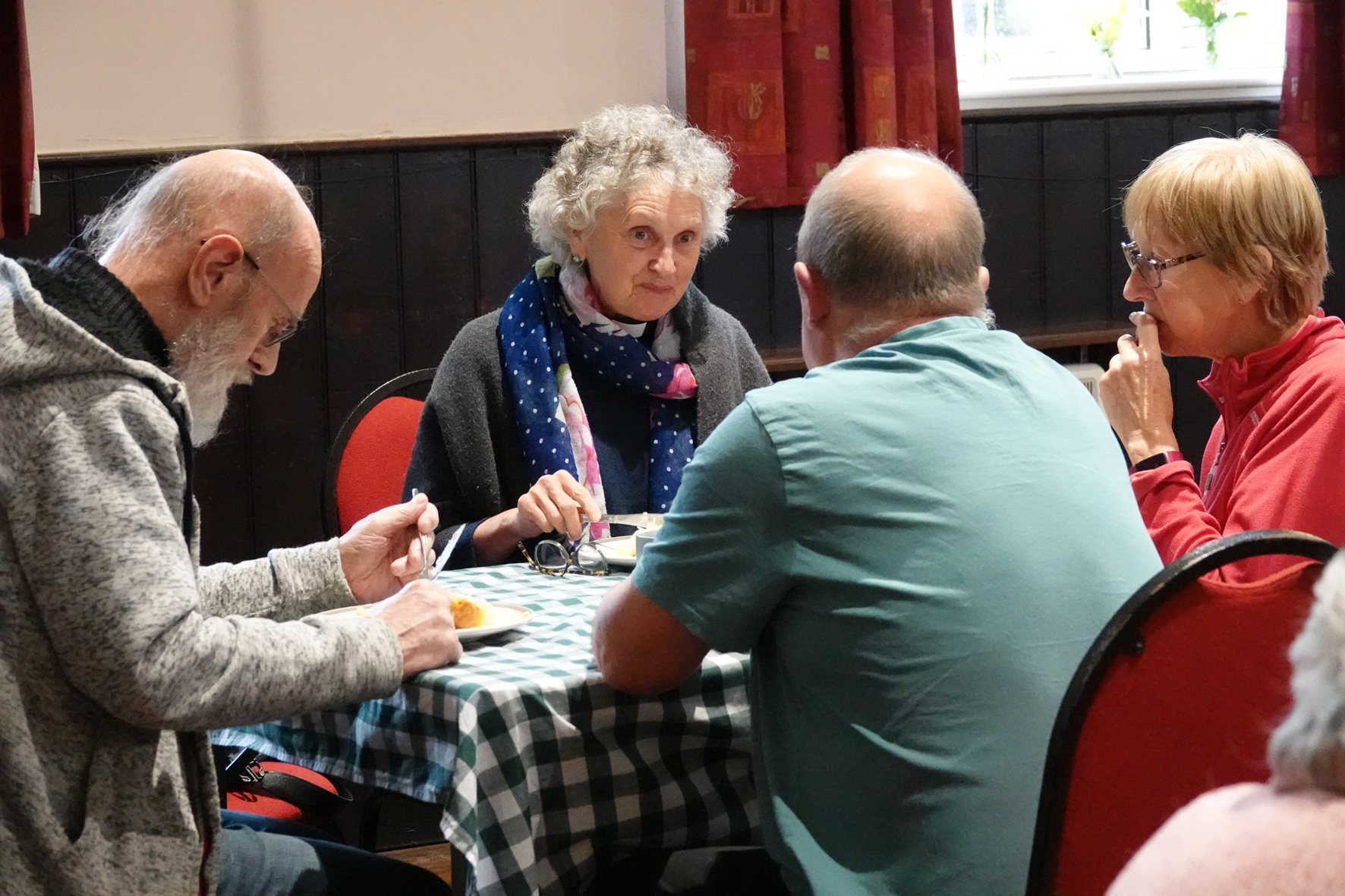 The Revd Jen Denniston sitting eating lunch with three other people