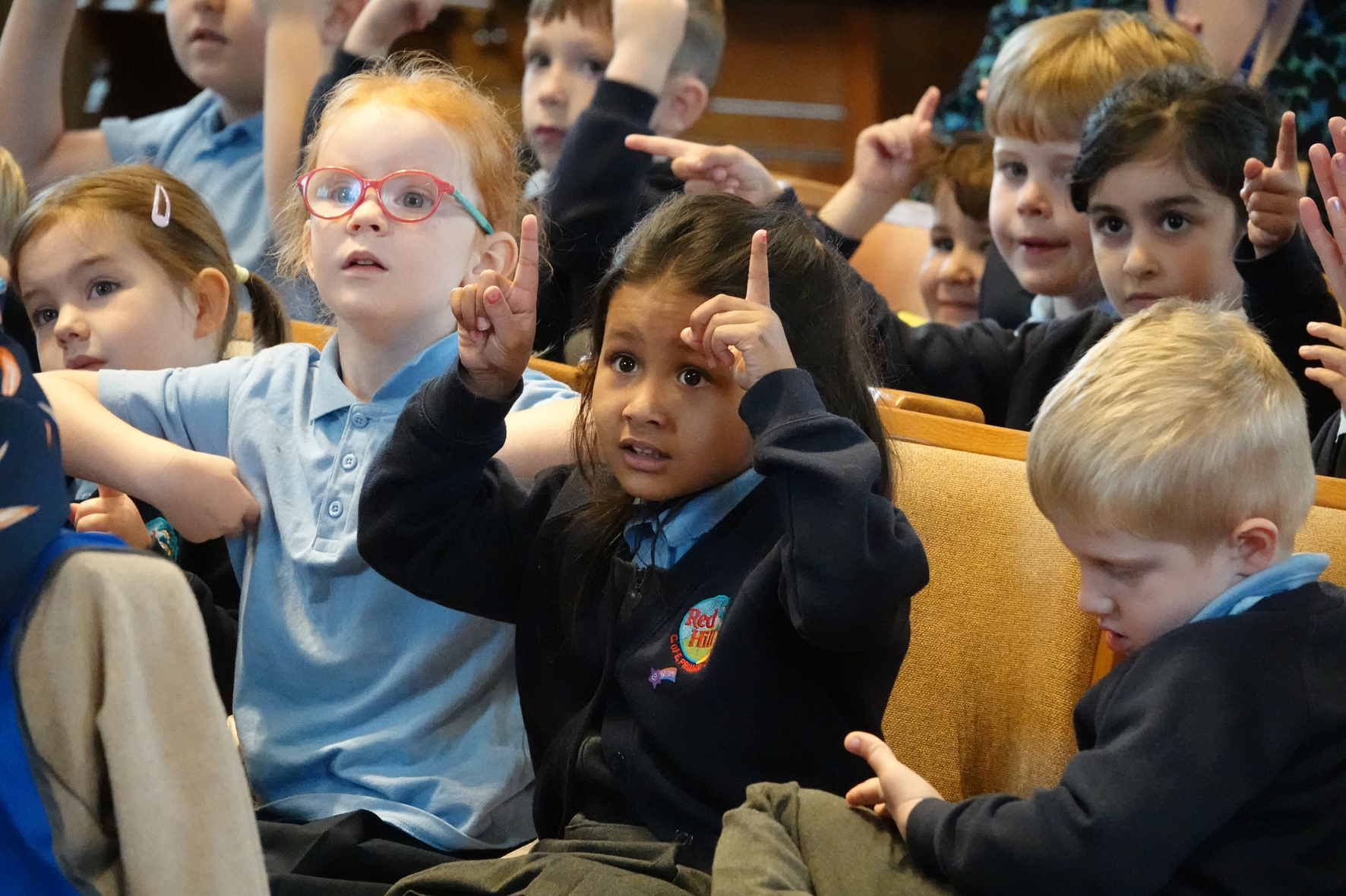 Pupils from Red Hill Primary School joining in actions during a song