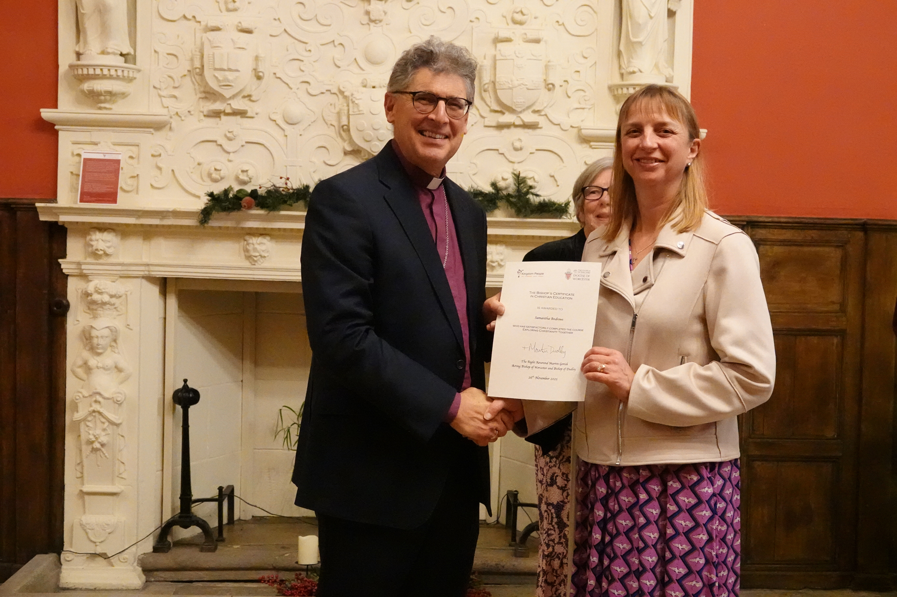 Sam Andrews receiving her Bishop's Certificate from Bishop Martin