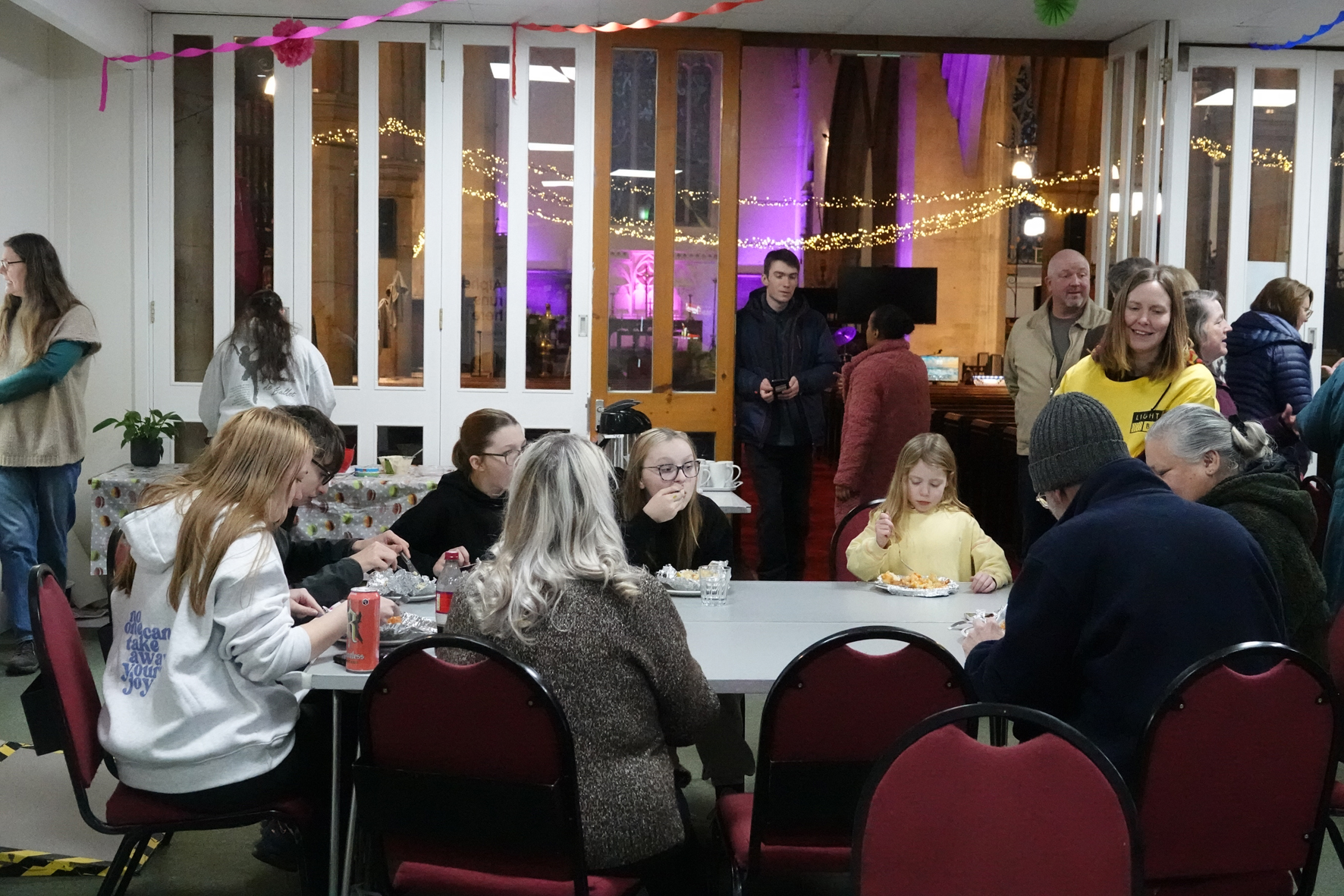  A group of people sitting around a table eating food together