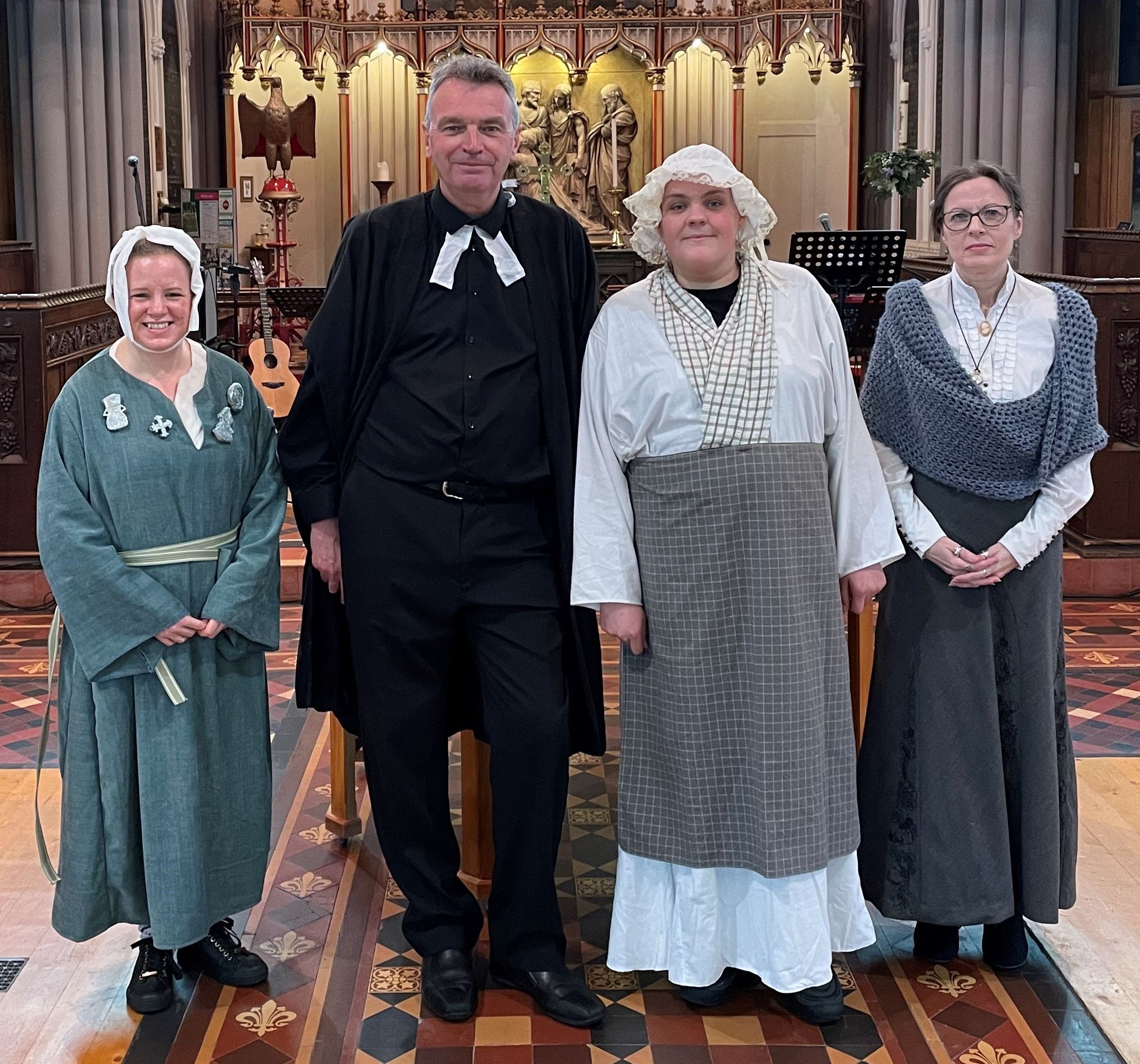 Four members of Top Church congregation pose in period dress