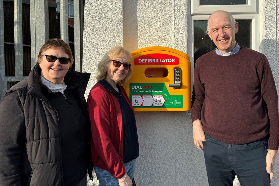 Catherine Mitchell, Jan Humphries and Steve Carpenter standing next to the new defibrillator