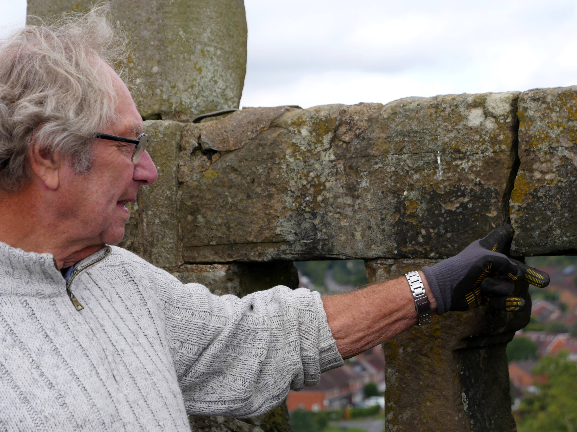 Tower captain looks at some of the damage on the tower of St Laurence Church