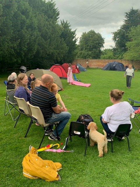 People sitting outside tents in Tardebigge