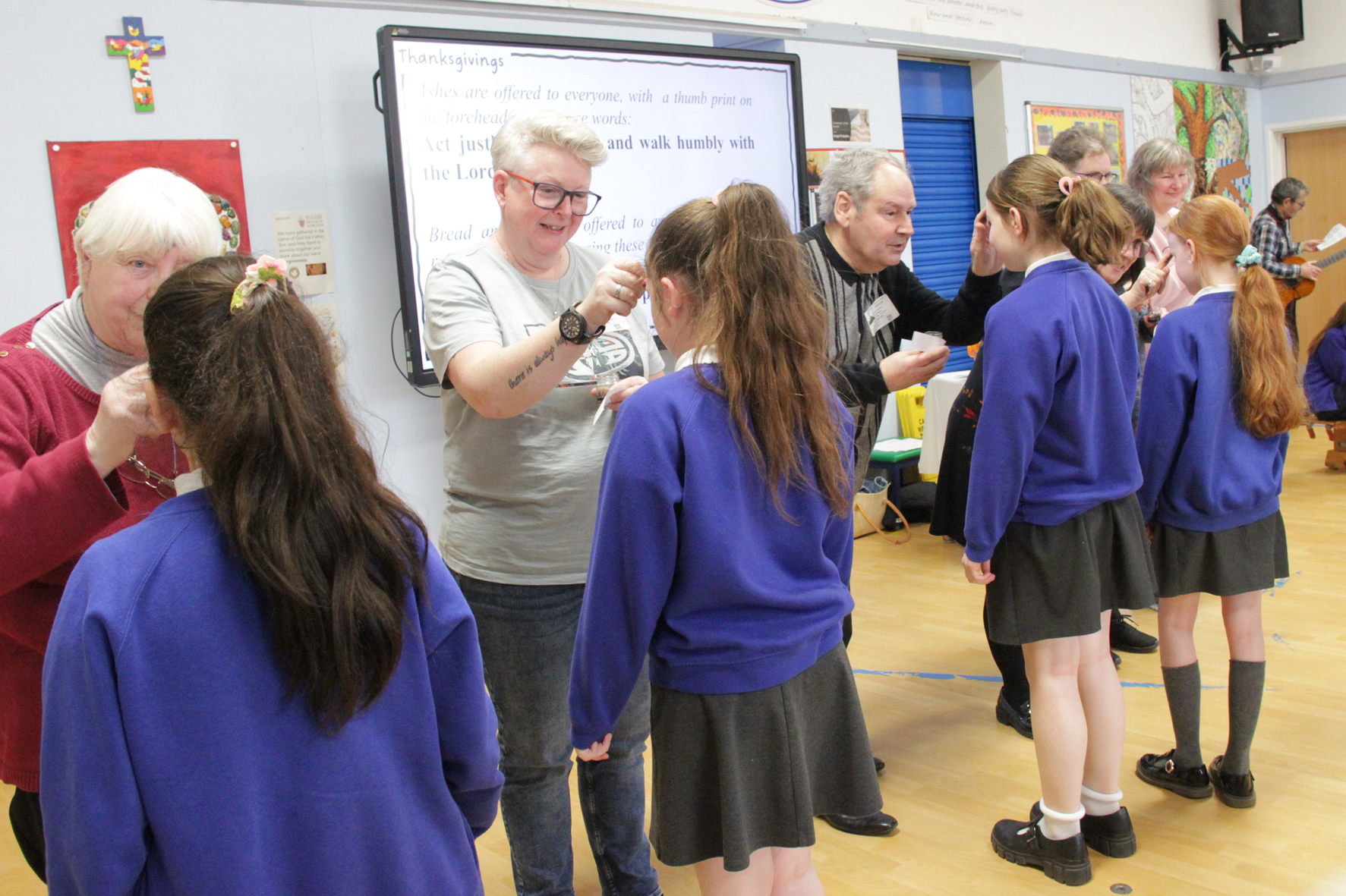 Students from St Barnabas primary receiving ashes from church members in the school hall