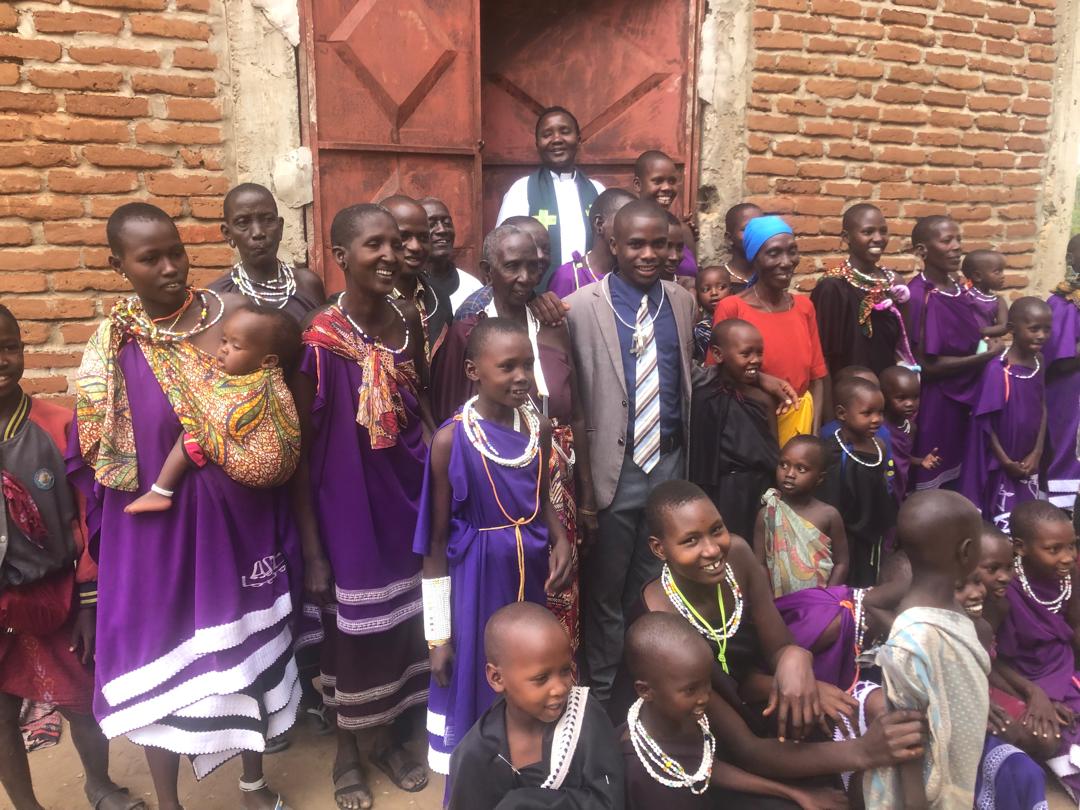 Maasai people standing outside a church building in Morogoro