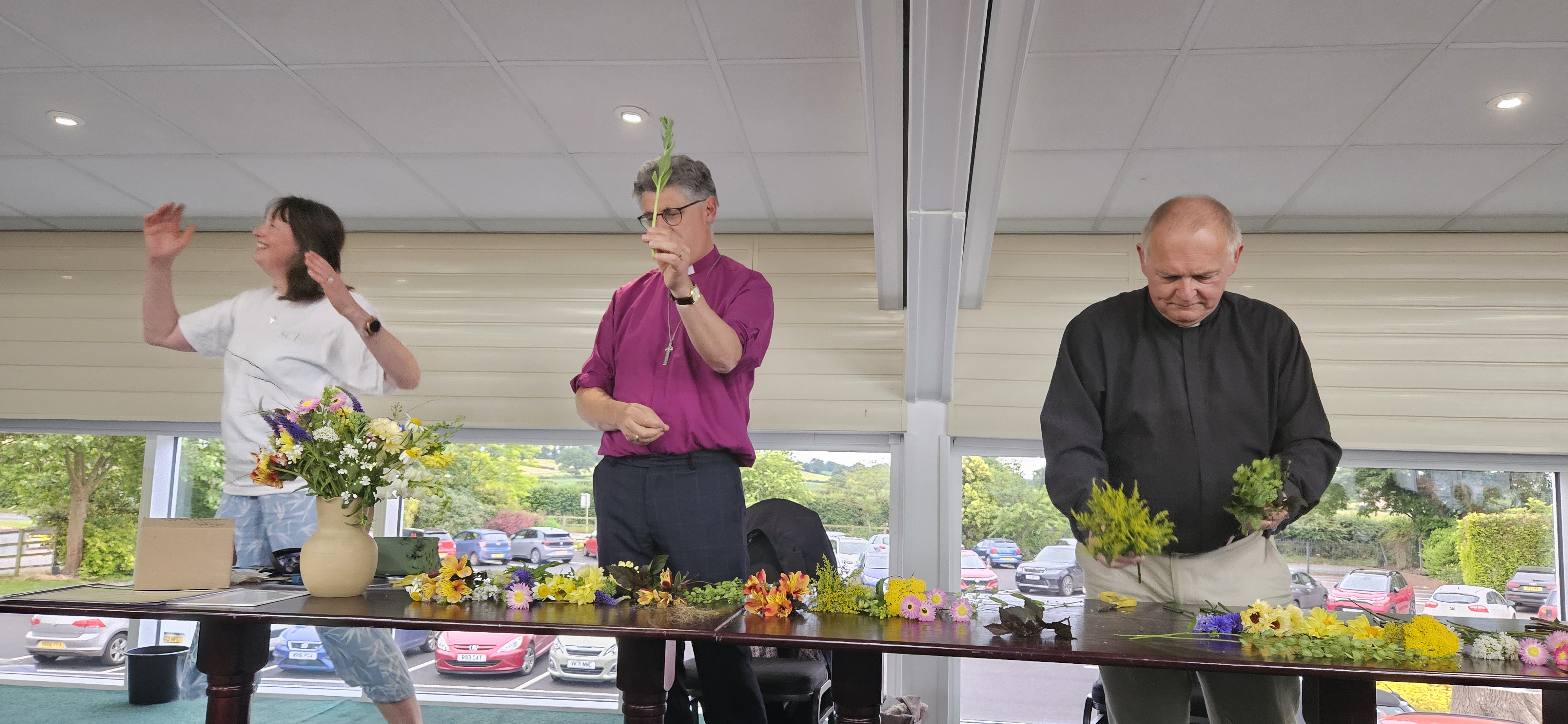 Bishop Martin & Tim Williams being helped  in sustainable flower arranging