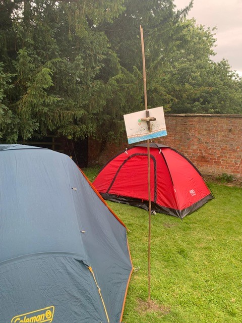 Two tents with a cross outside