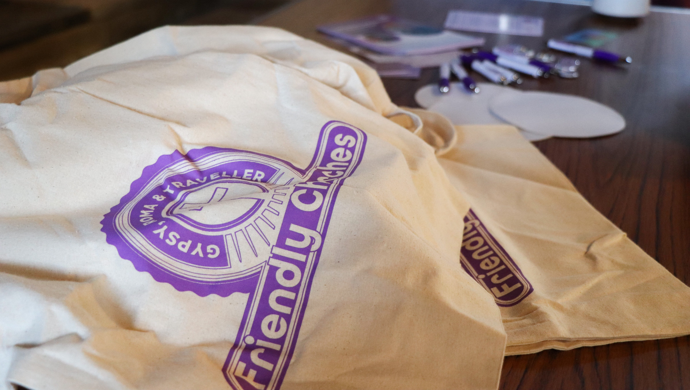 A pile of Gypsy Roma Traveller Friendly tote bags