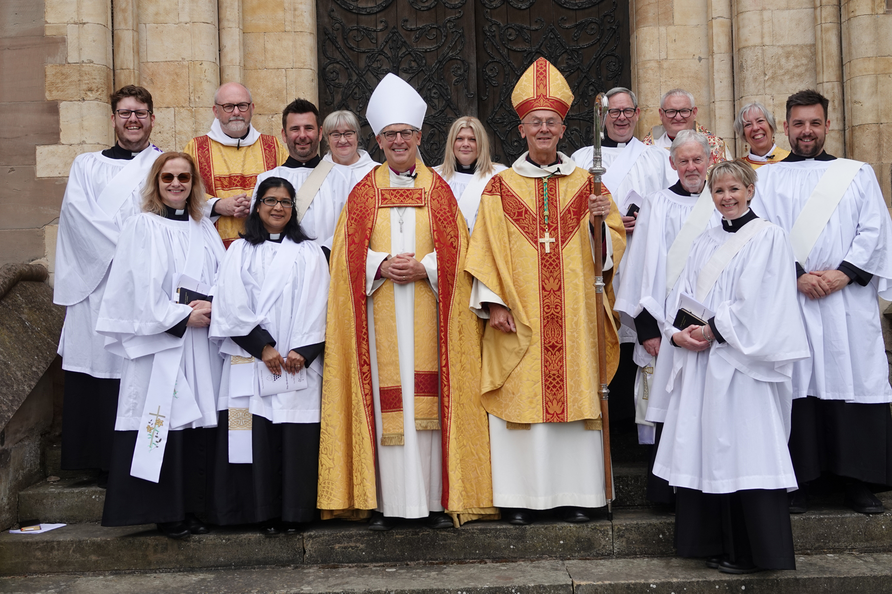 Newly ordained deacons standing outside the cathedral with the bishops