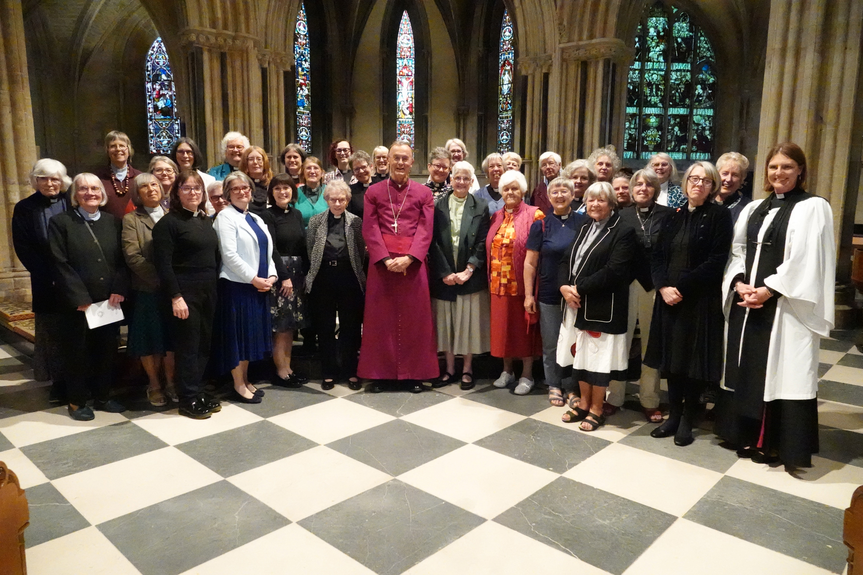 Female clergy from across the diocese in Pershore Abbey with Bishop John