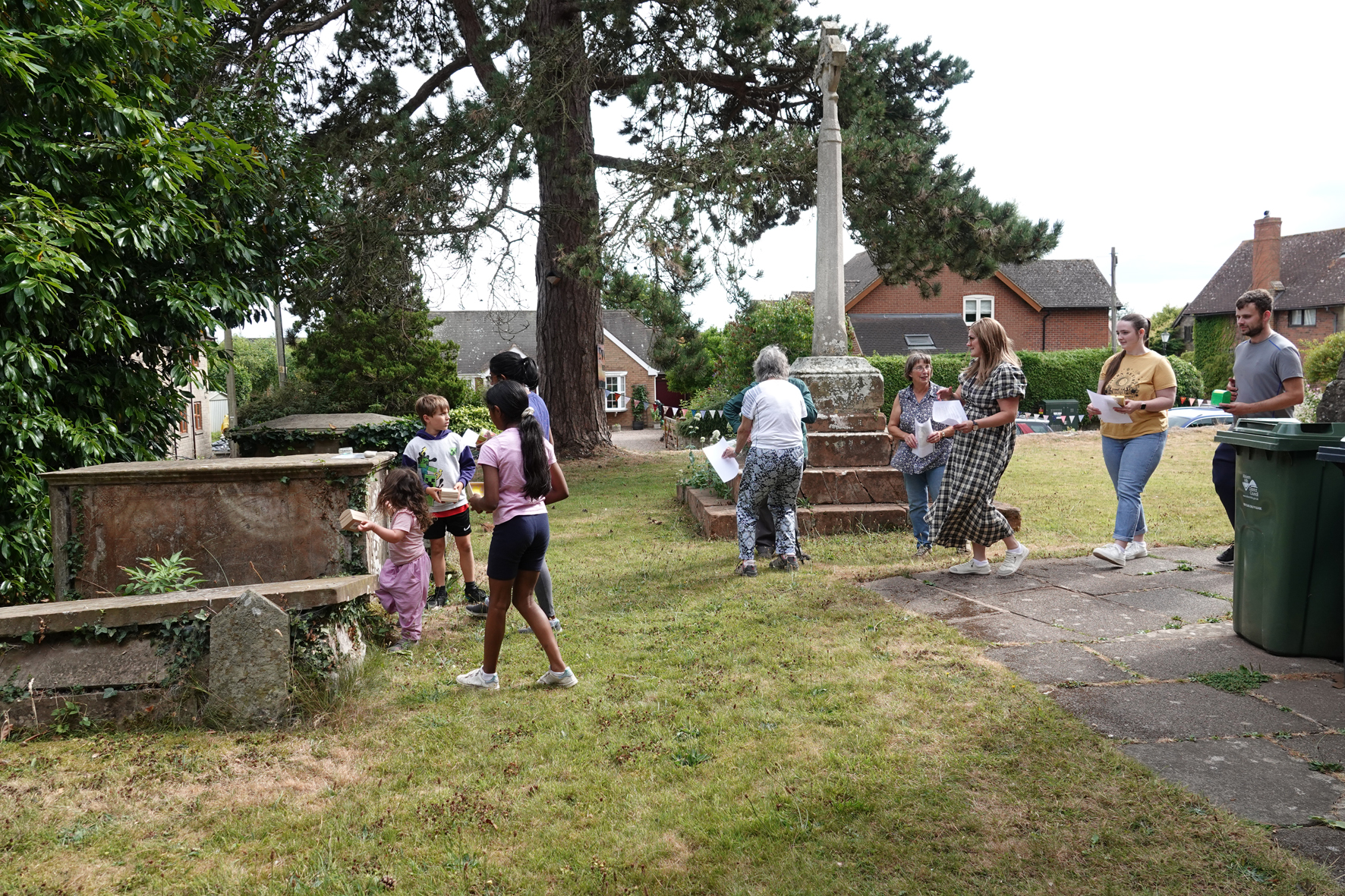 People walking around the churchyard in Clifton on Teme