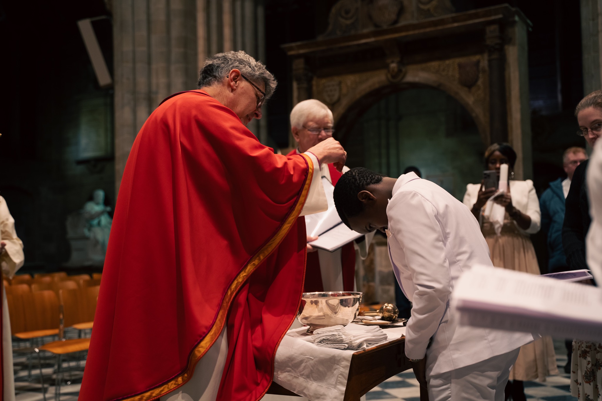 Bishop Martin baptising a young boy