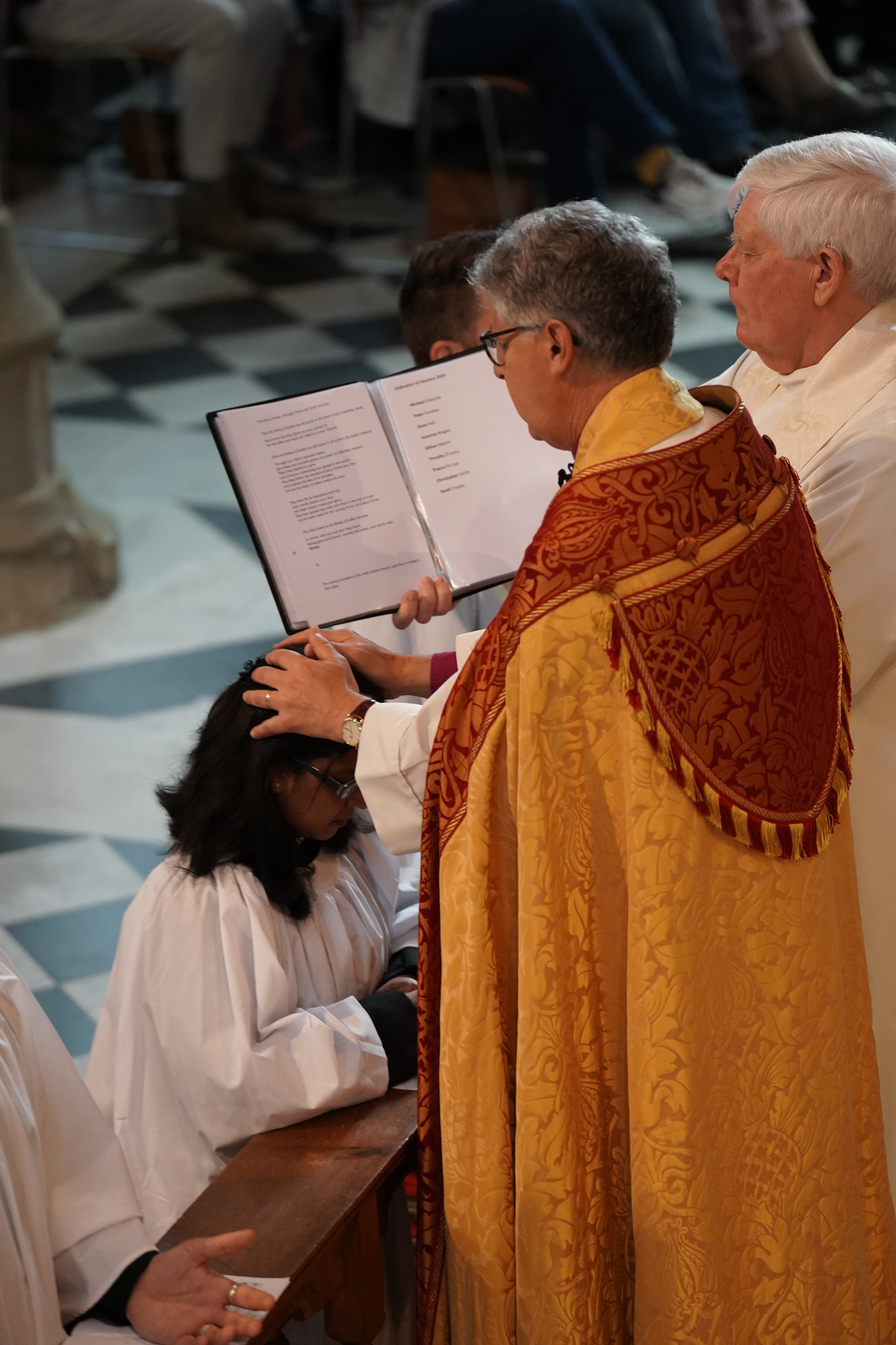 Prajna Pal-Lad is being ordained by the Bishop of Dudley with the Bishop's Chaplain standing alongside