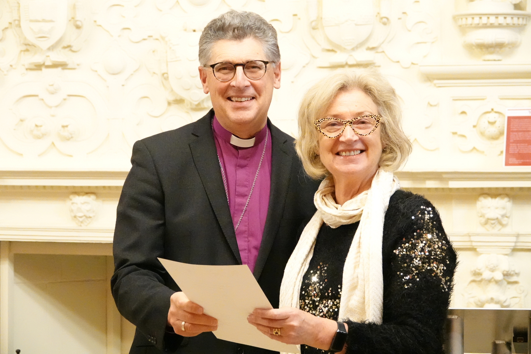 Bishop Martin standing with Penny Gordon who is holding her Bishop's certificate