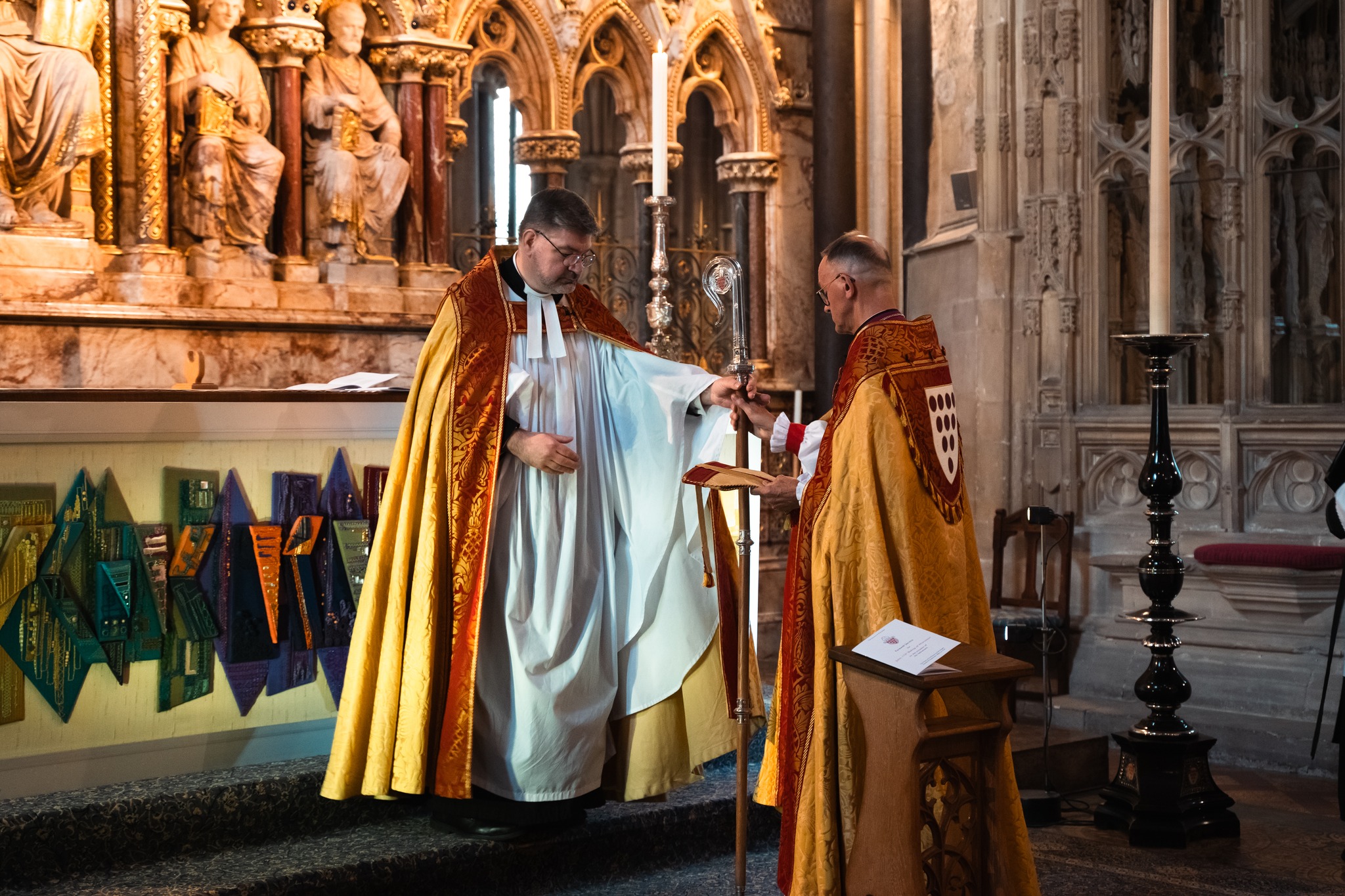 Bishop John handing over the diocesan staff to the dean