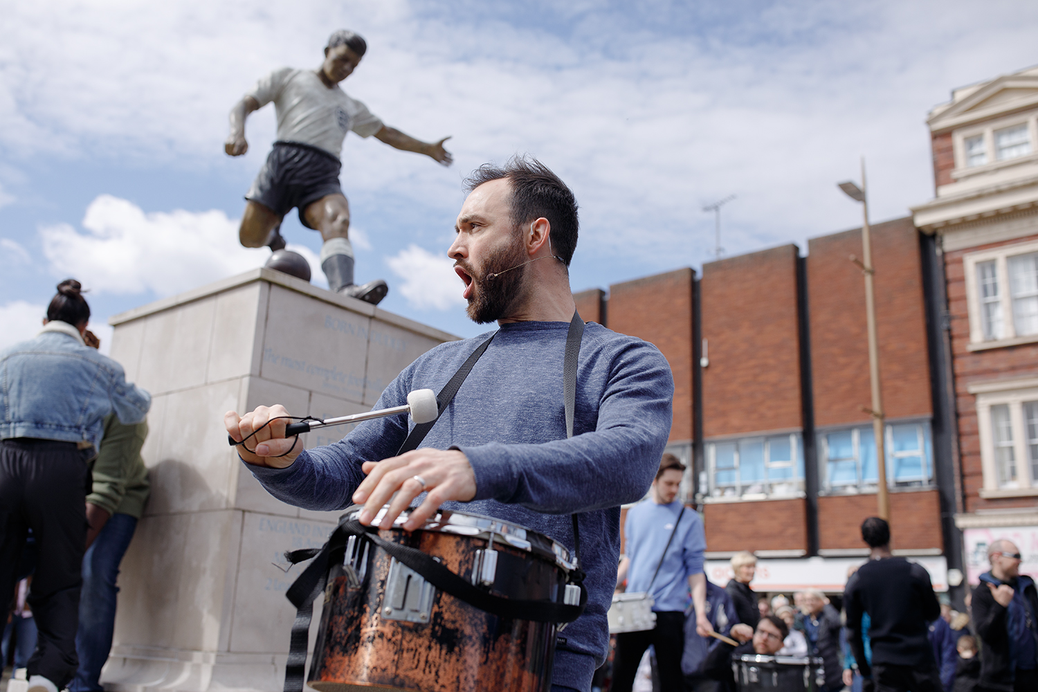 Drummer at the passion play in front of a statue of Duncan Edwards in Dudley town centre