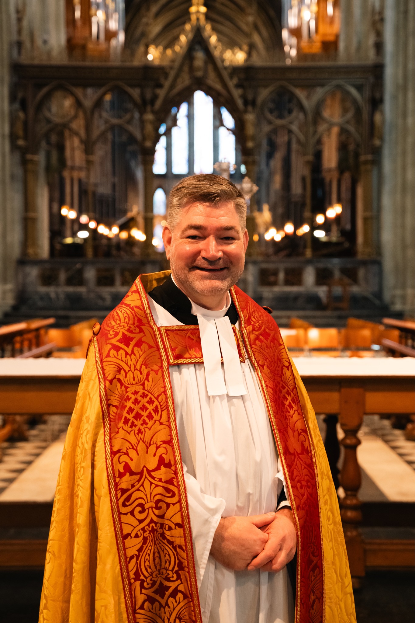 Stephen Edwards in his Dean's robes front of the altar in the Cathedral