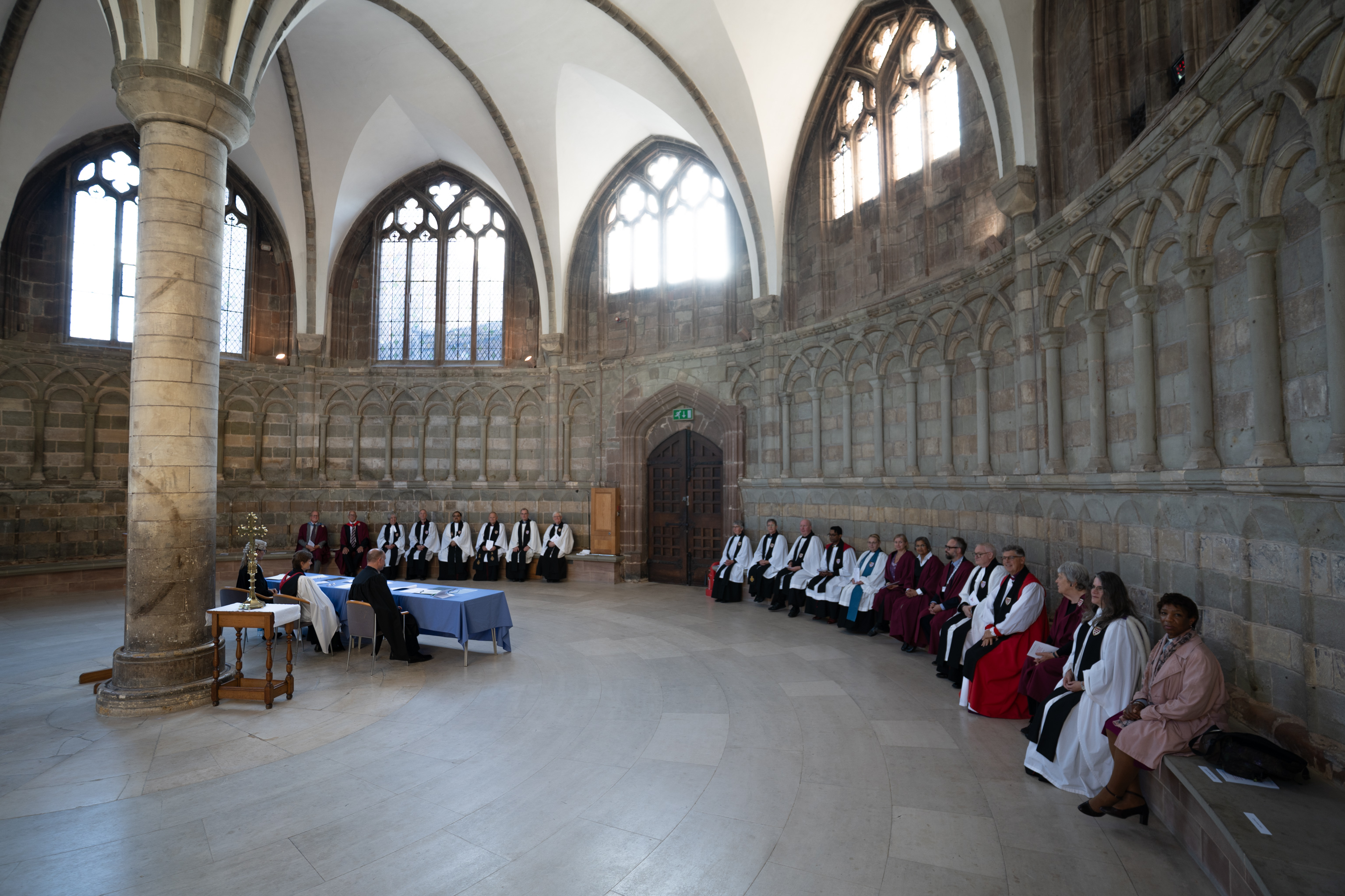 College of Canons sitting around the edge of the Chapter house for the election of Bishop Hugh