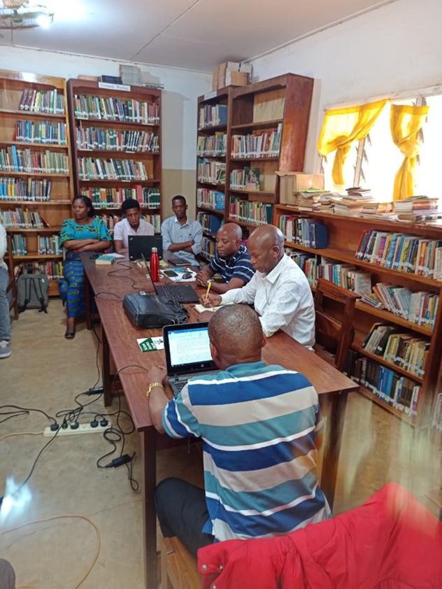 People sat around a table studying in the library of the Morogoro Bible College