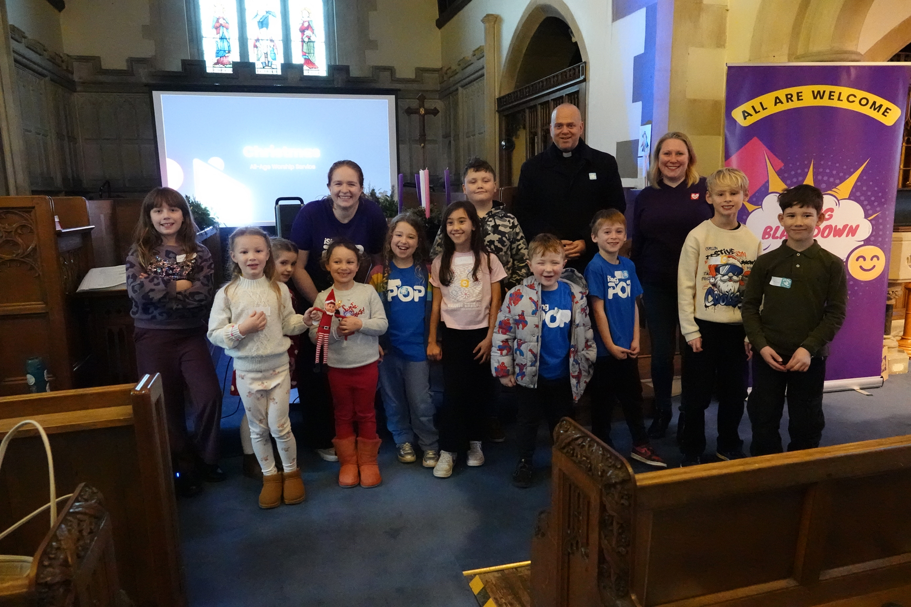 A group of children standing with Shaun Armstrong and Kirsty Pierson at the front of Blakedown church