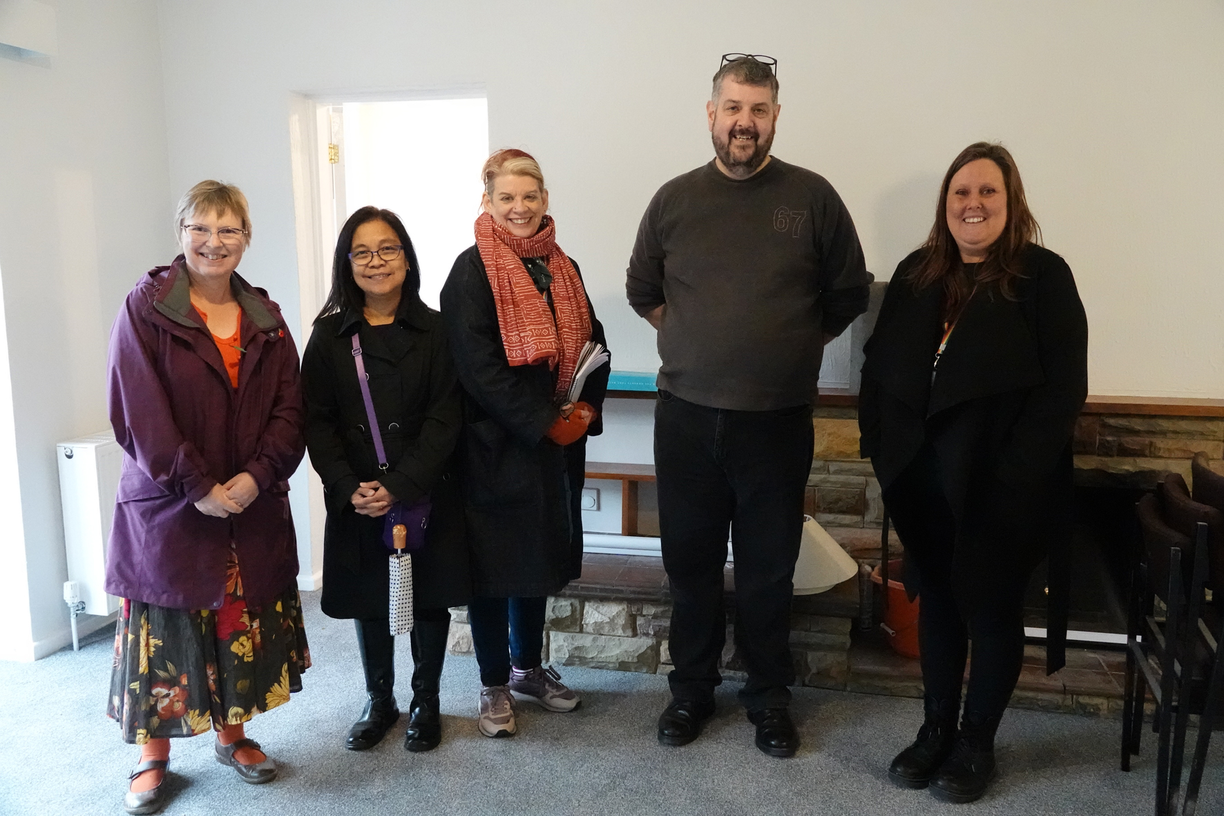 Four members of the clergy housing team standing inside Harvington rectory with Glenn Reading