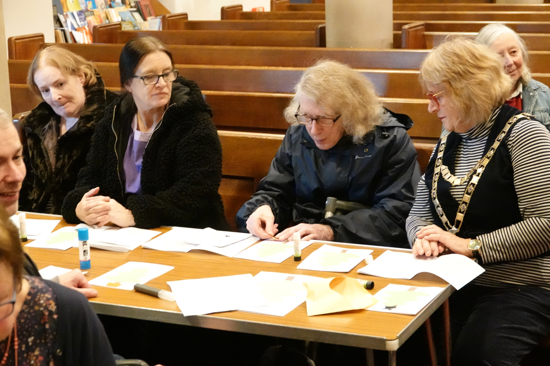 People doing craft around a table including the Mayor of Malvern