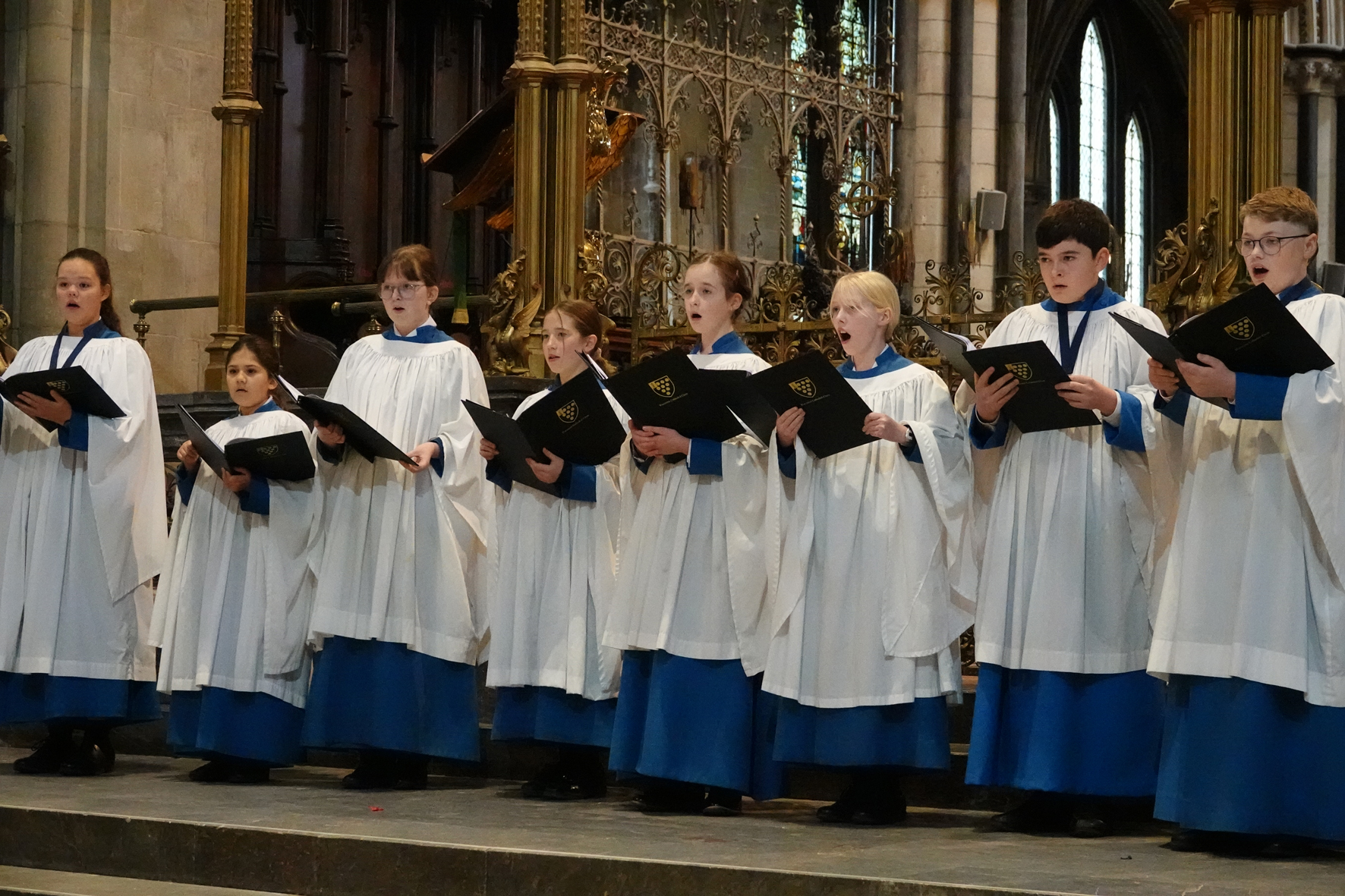 The Cathedral Voluntary choir singing on the steps to the Quire