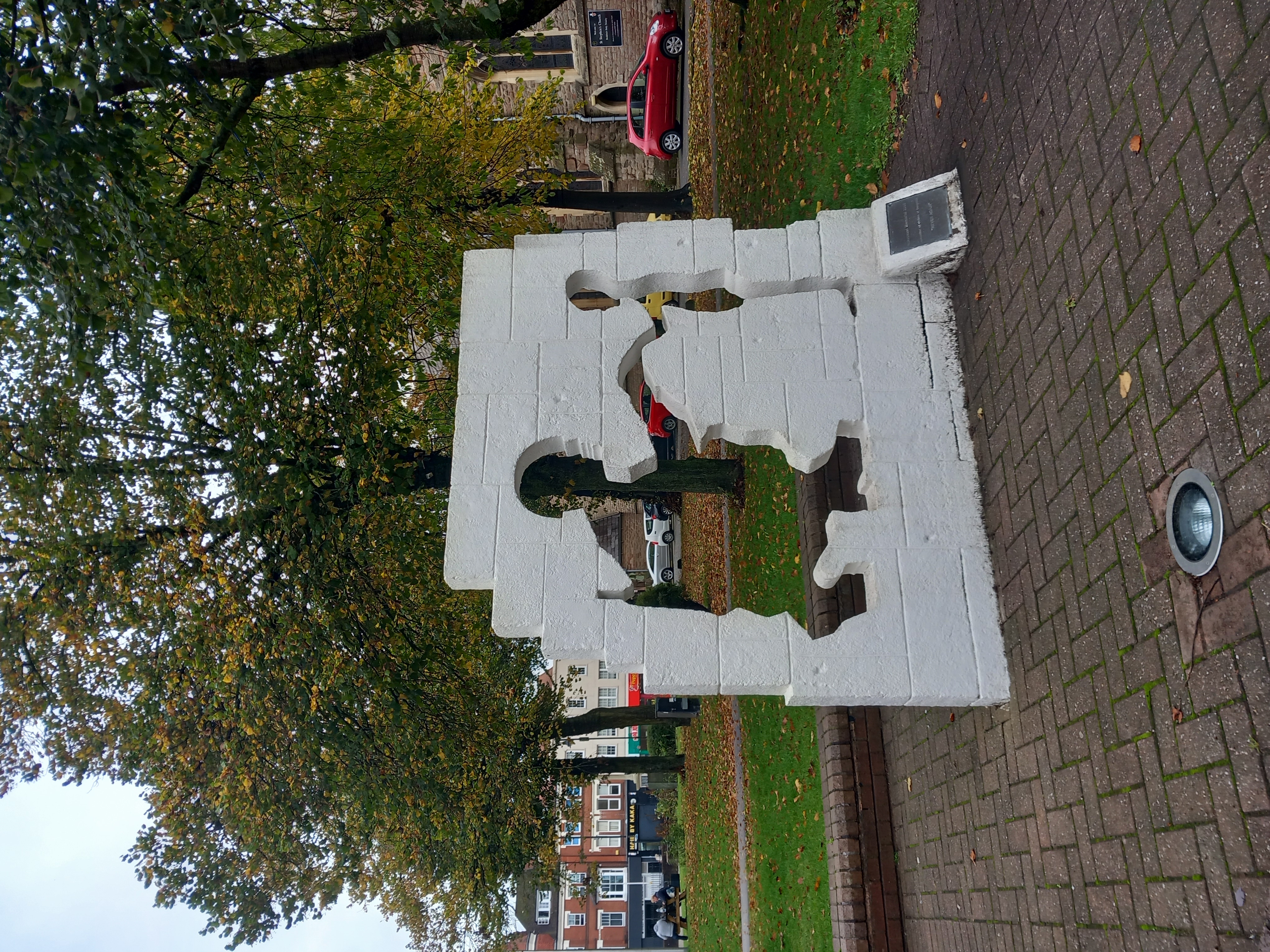 Holocaust memorial of a soldier kneeling in front of a child and holding their hand