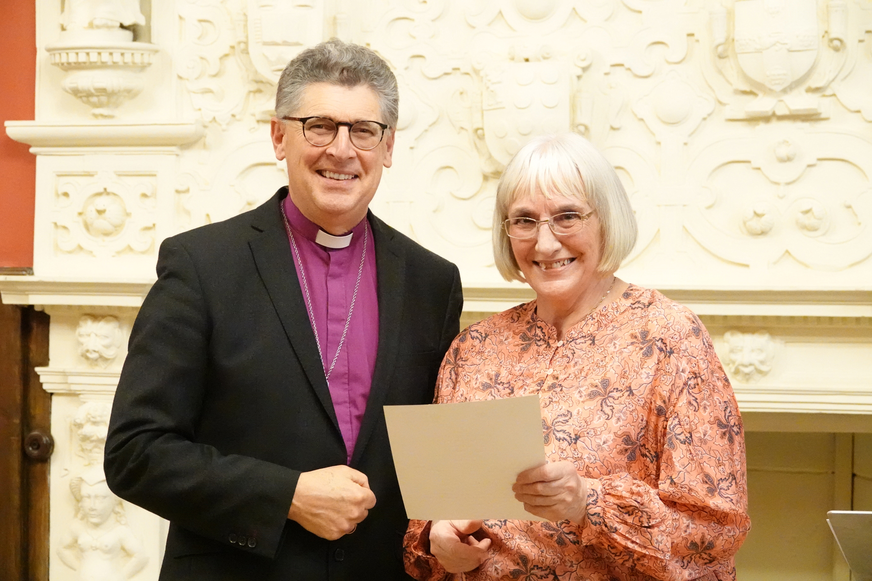 Bishop Martin stands with Roslie Bullock having just presented her Bishop's certificate