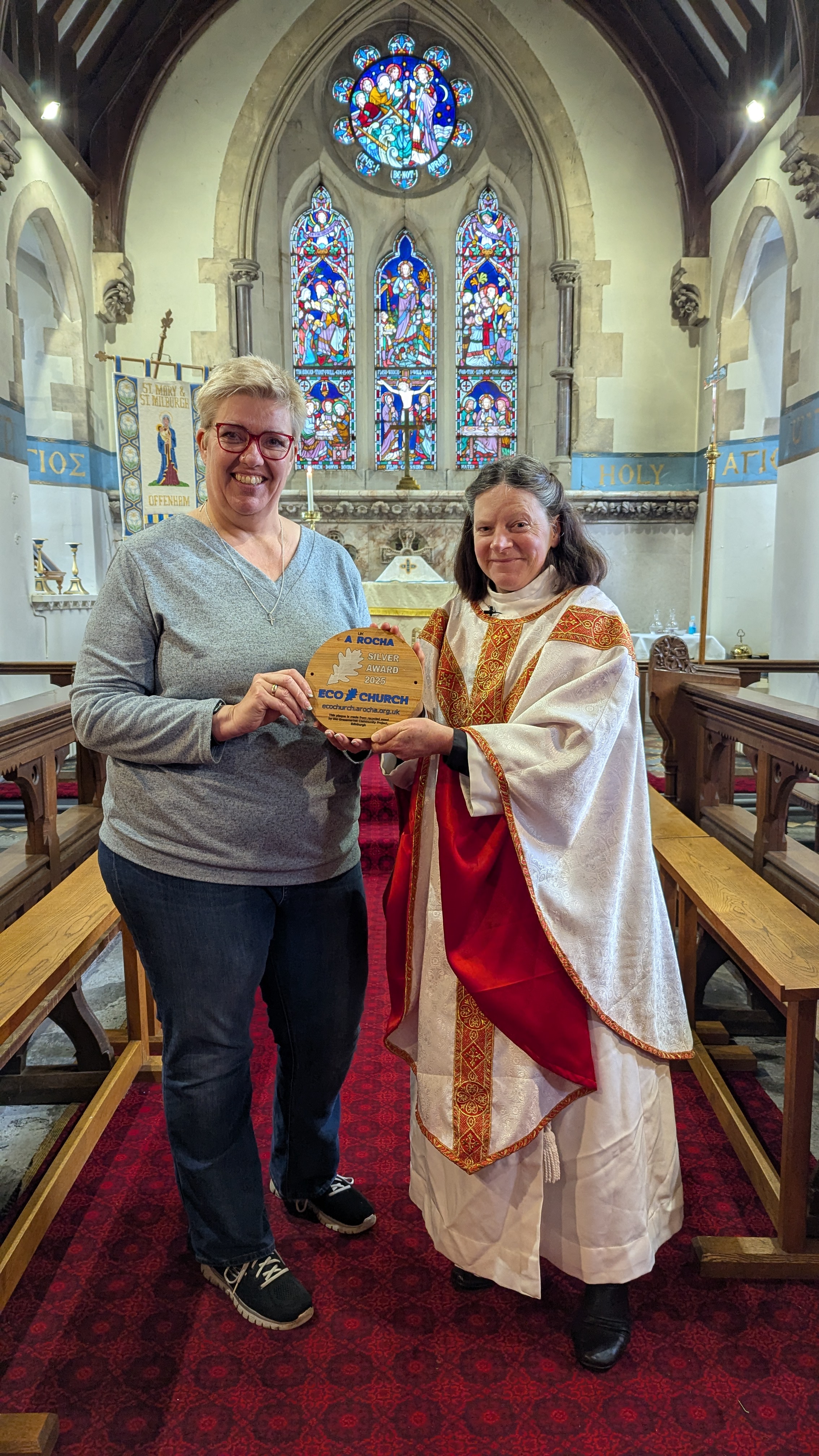 Debbie Harrison and the Revd Jo Fielding with a silver eco church award in Offenham Church