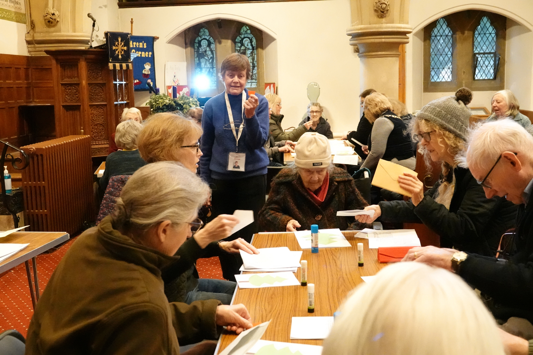 Eileen Tomlin explaining the craft to people sitting around a table