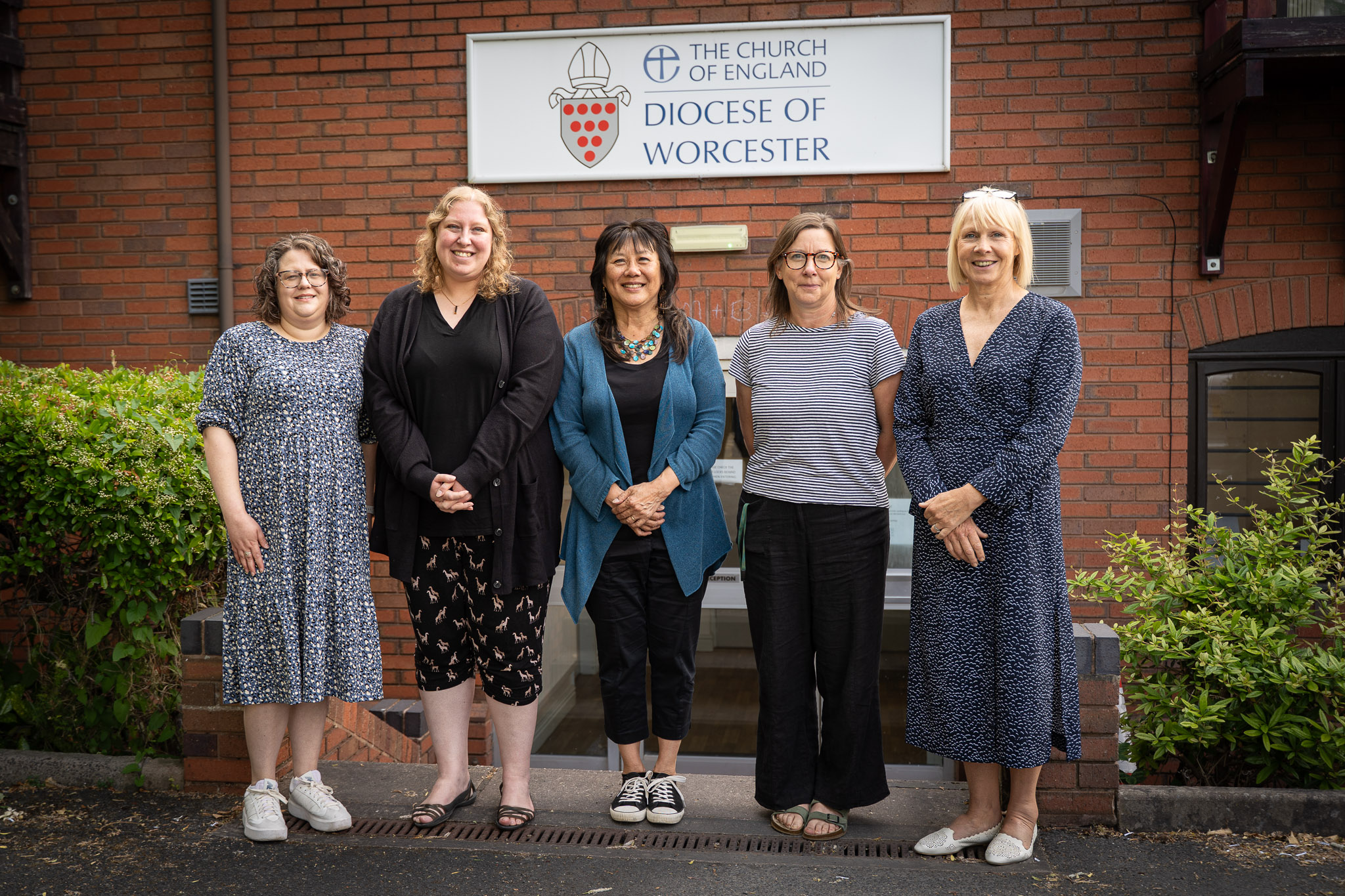 Diocesan safeguarding team standing in front of the sign for the diocesan office