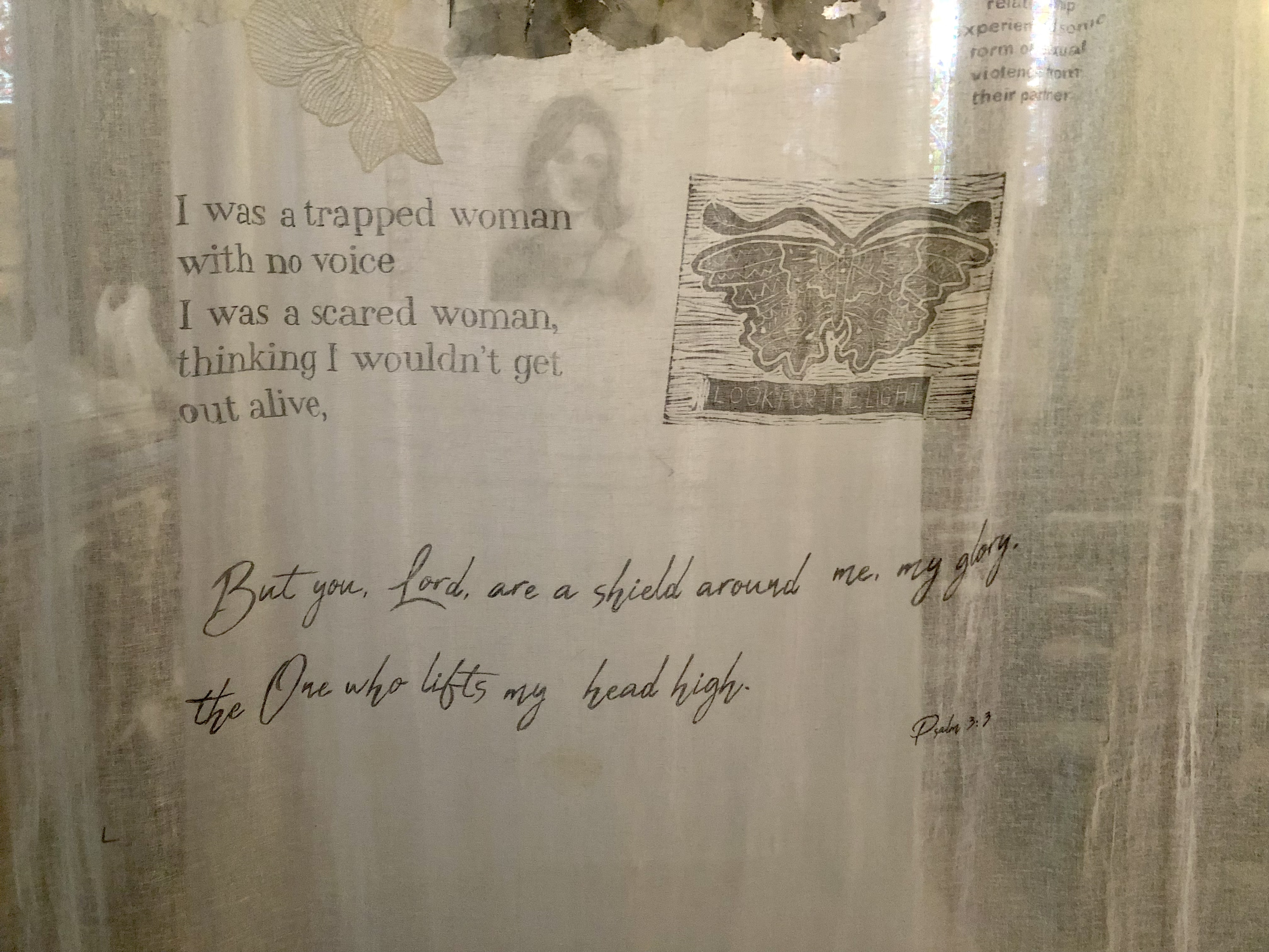 Close up of one of the hangings featuring the words of a survivor