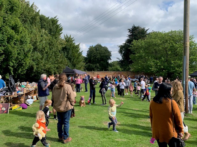 People gathered on the church lawn at Tardefest