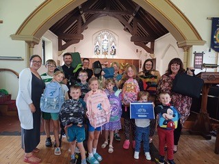 children and adults posing with their bags at Wall Heath church