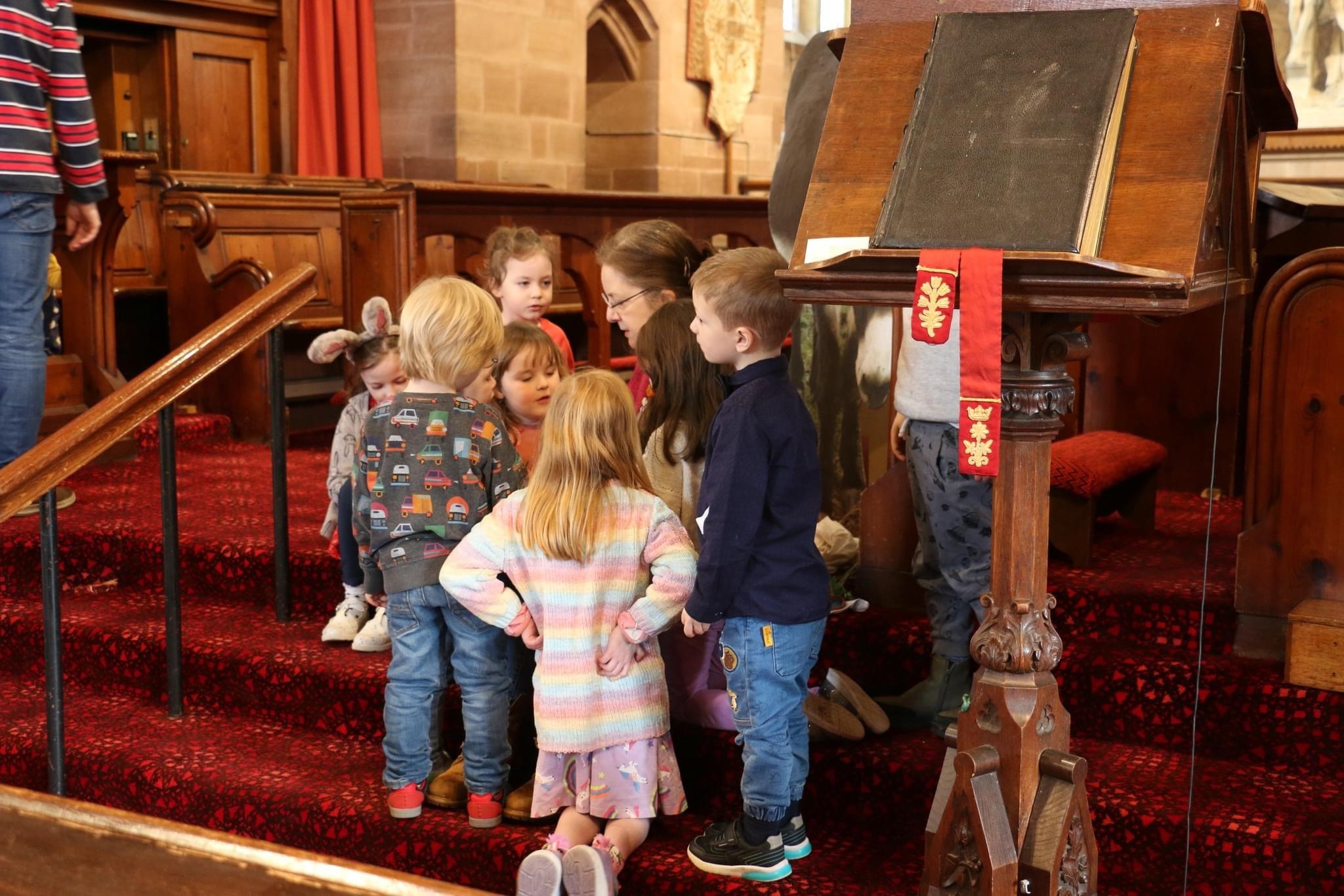 The children gather on the steps to hear a story