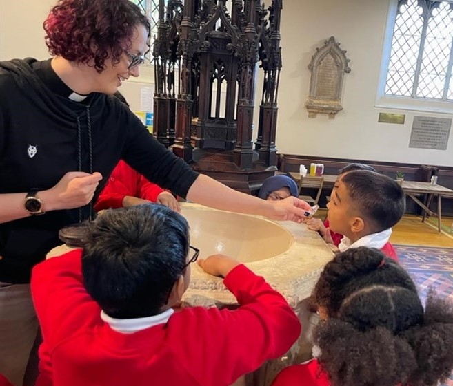 children learning about the font at Top Church