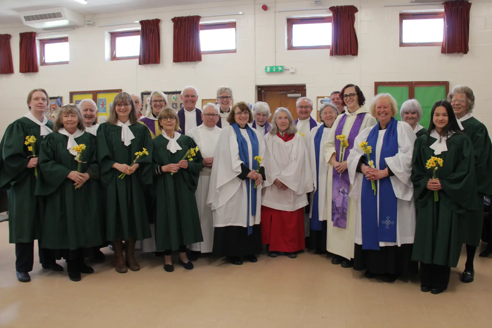 Ministers and choir members from three churches in Worcester standing together in a church hall.